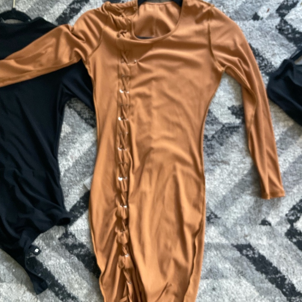 Two body suits . One black lace up body suit, one brown good skin body suit